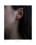 Tri Colocho Earring worn on a model's ear, a solid 18k yellow gold twisted drop earring with soft organic curves. Tarnish-resistant and made for everyday wear — Maya & Mason handcrafted fine jewellery.