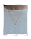 Colocho Pendant, a solid 18k gold necklace with a small twisted pendant, worn on a model's neck. Tarnish-resistant and made for everyday wear — Maya & Mason handcrafted fine jewellery.