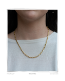 Colorado Chain, a solid 18k gold chainlink necklace worn on a model's neck over a light gray top. Tarnish-resistant and made for everyday wear — Maya & Mason handcrafted fine jewellery.