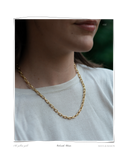 Colorado Chain, a close-up of a solid 18k gold chainlink necklace with a polished finish, worn over a white t-shirt. Tarnish-resistant and made for everyday wear — Maya & Mason handcrafted fine jewellery.