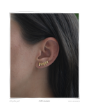 Pebble Ear Climbers worn on a model's ear, a solid 18k gold pebble-shaped ear climber tracing the curve of the ear. Tarnish-resistant and made for everyday wear — Maya & Mason handcrafted fine jewellery.