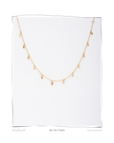 Mini Curl Necklace, laid flat on a white background, a solid 18k yellow gold layered necklace with small curl and teardrop charms. Tarnish-resistant and made for everyday wear — Maya & Mason handcrafted fine jewellery.