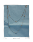 Aquamarine White Gold necklace, styled on a blue fabric background, a layered solid 18k white gold necklace set with aquamarine stones. Tarnish-resistant and made for everyday wear — Maya & Mason handcrafted fine jewellery.