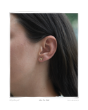 Mini Trio Studs worn on a model's ear, solid 18k gold sculpted stud earrings with softly twisted fluid forms. Tarnish-resistant and made for everyday wear — Maya & Mason handcrafted fine jewellery.
