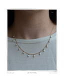 Pearl Mini Necklace, worn on a model's neck, a solid 18k gold chain necklace with dangling freshwater pearls. Tarnish-resistant and made for everyday wear — Maya & Mason handcrafted fine jewellery.
