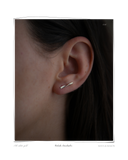 Colocho Ear Climber, White Gold worn on a model's ear, a solid 18k white gold ear climber. Tarnish-resistant and made for everyday wear — Maya & Mason handcrafted fine jewellery.