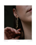 Eu Earrings, close-up lifestyle shot of model wearing a gold dangle earring, solid 18k yellow gold. Tarnish-resistant and made for everyday wear — Maya & Mason handcrafted fine jewellery.