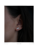 First Date Studs, White Gold worn on a model's ear, a solid 18k white gold stud earring with subtle organic curves. Tarnish-resistant and made for everyday wear — Maya & Mason handcrafted fine jewellery.