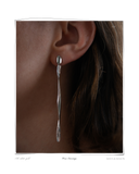 Verse Earring, White Gold, close-up worn on a model's ear, an elongated solid 18k white gold drop earring. Tarnish-resistant and made for everyday wear — Maya & Mason handcrafted fine jewellery.