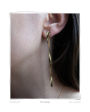 Verse Earring, Yellow Gold, close-up worn on a model's ear, an elongated solid 18k yellow gold drop earring. Tarnish-resistant and made for everyday wear — Maya & Mason handcrafted fine jewellery.